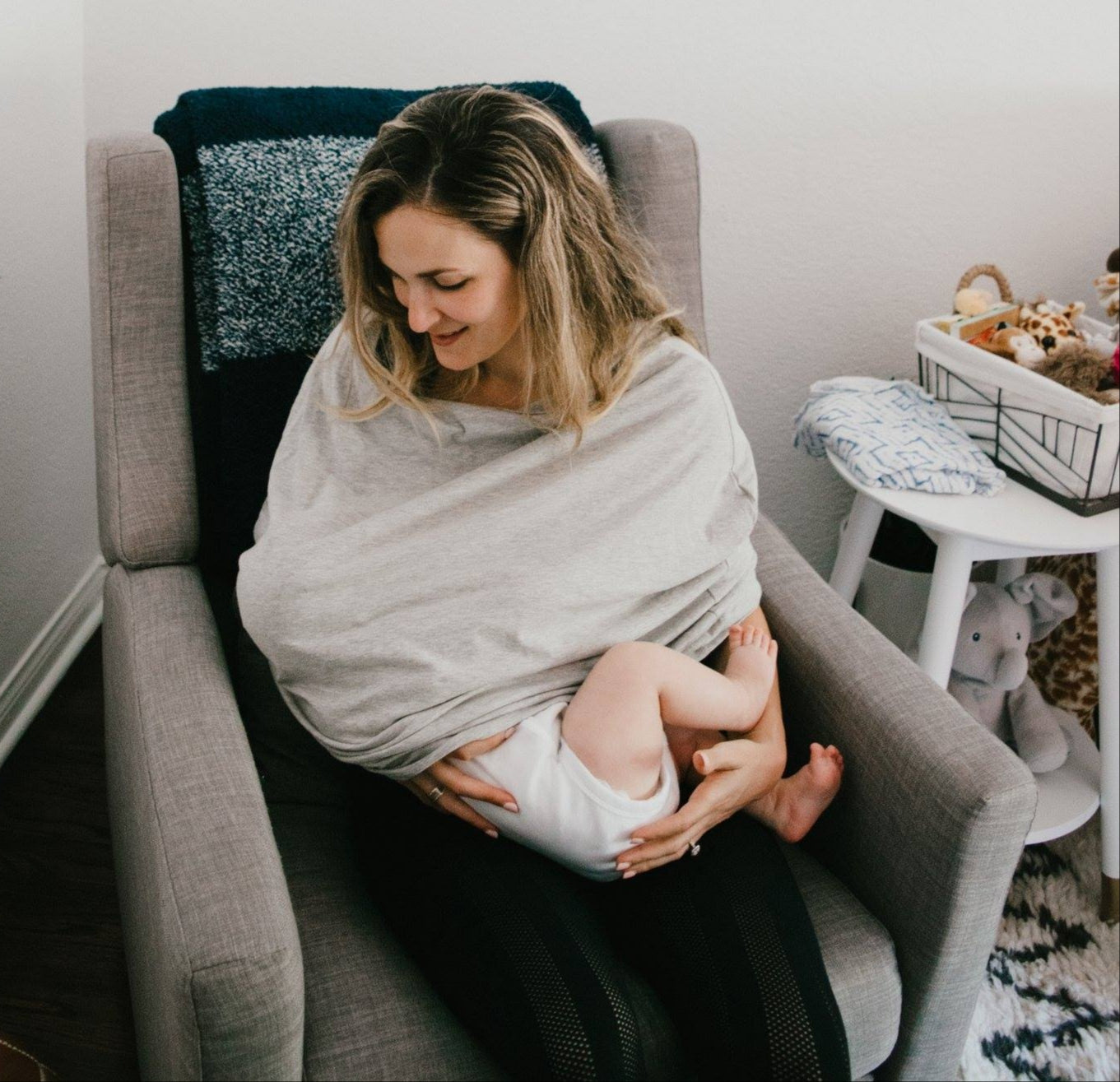 baby nursing cover used for breast feeding on a chair.