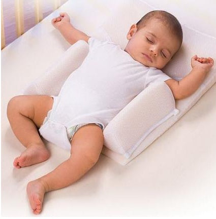 infant sleep support cushion with baby on top