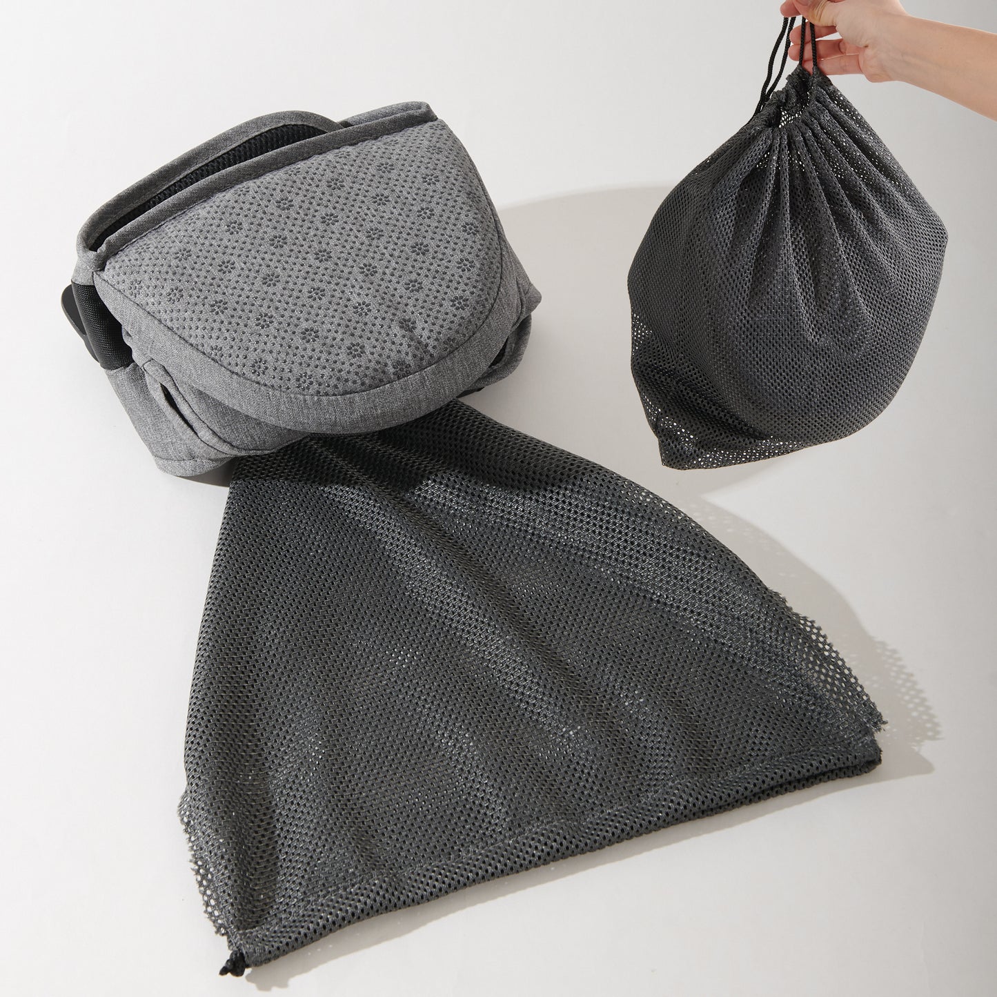 Collapsible hip seat carrier displayed with a mesh storage bag for easy portability and organization.