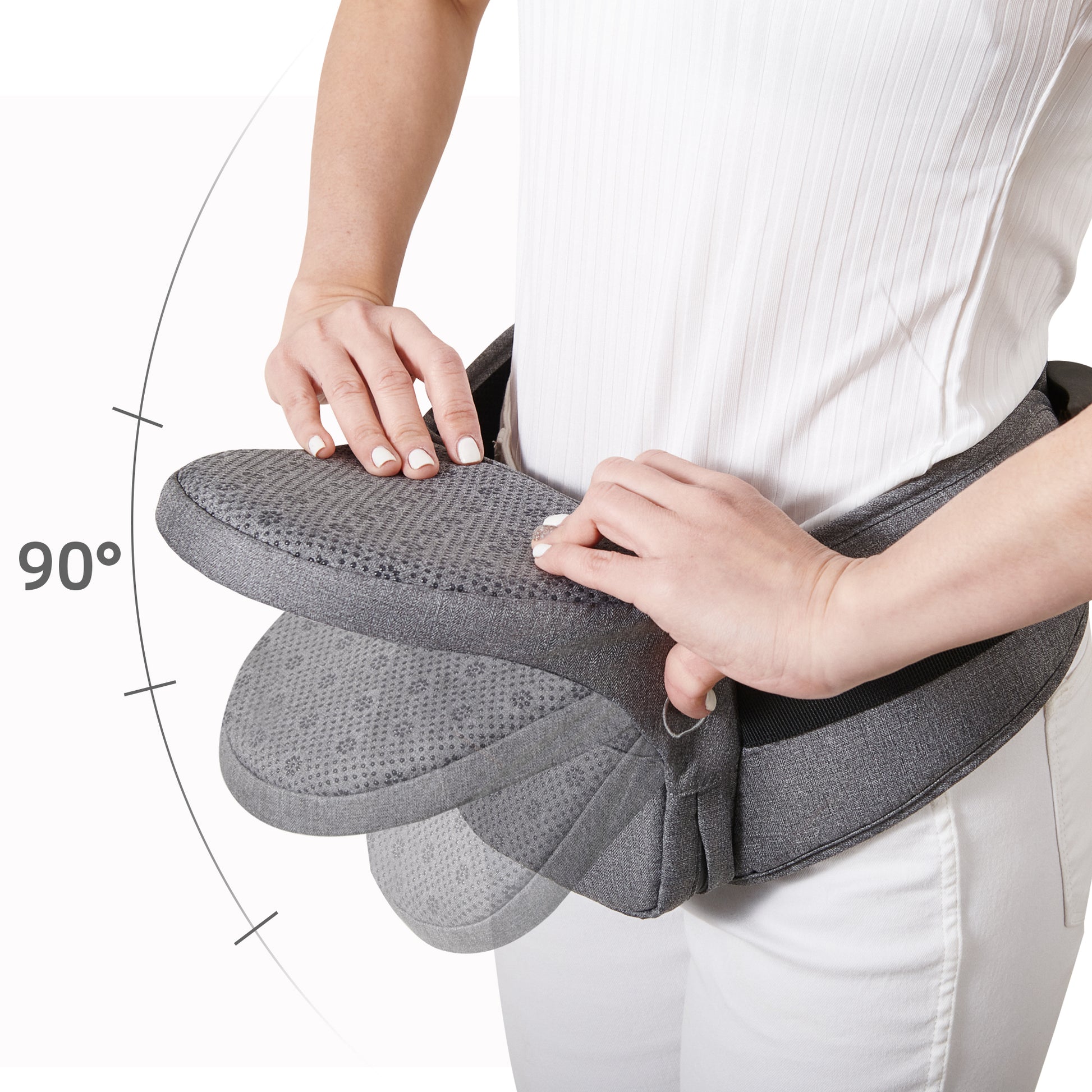 Collapsible hip seat carrier being adjusted, showcasing ergonomic design for comfort and portability.